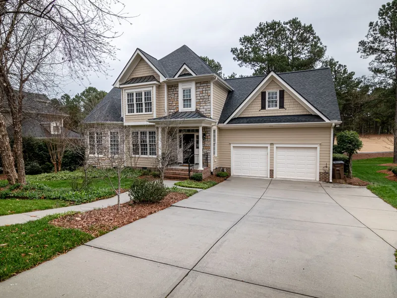 Suburban house with a two-car garage and a wide concrete driveway