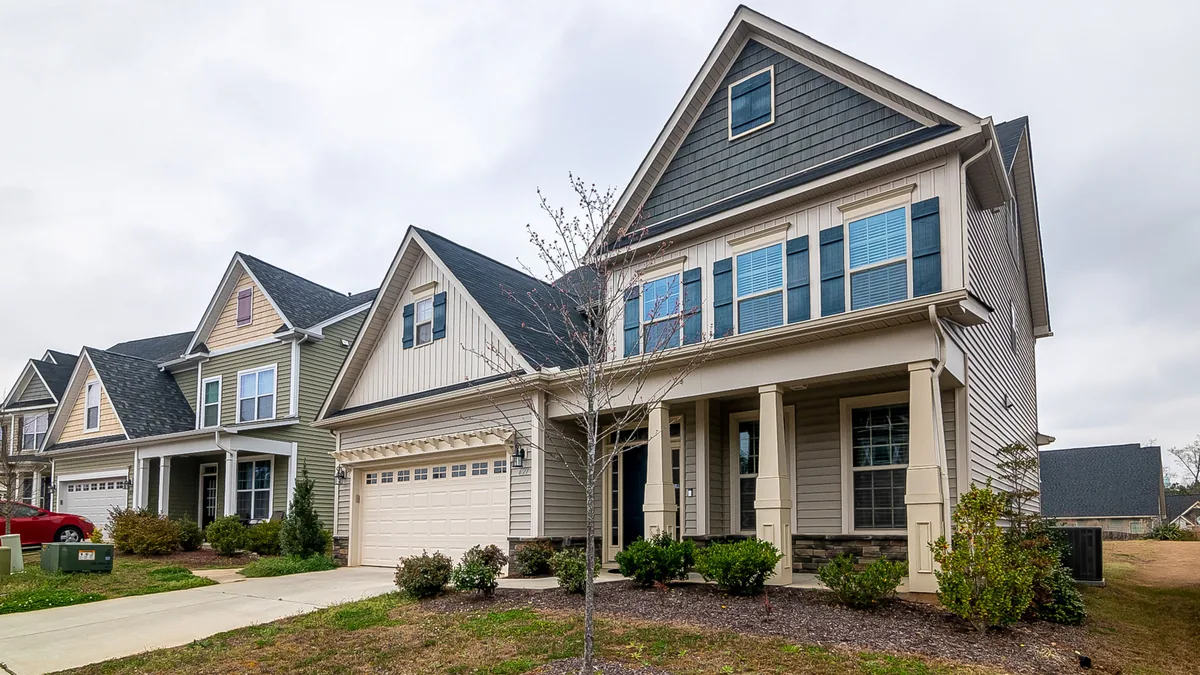 Row of modern suburban homes with attached garages and driveways