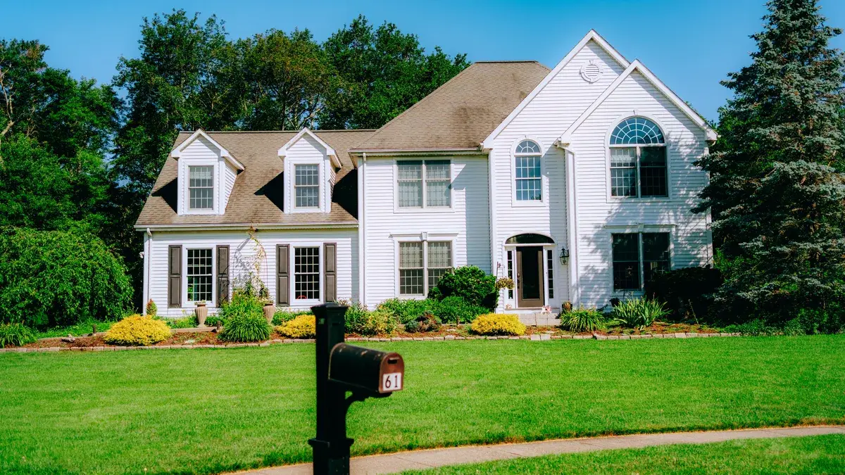 Suburban house exterior with a large green lawn