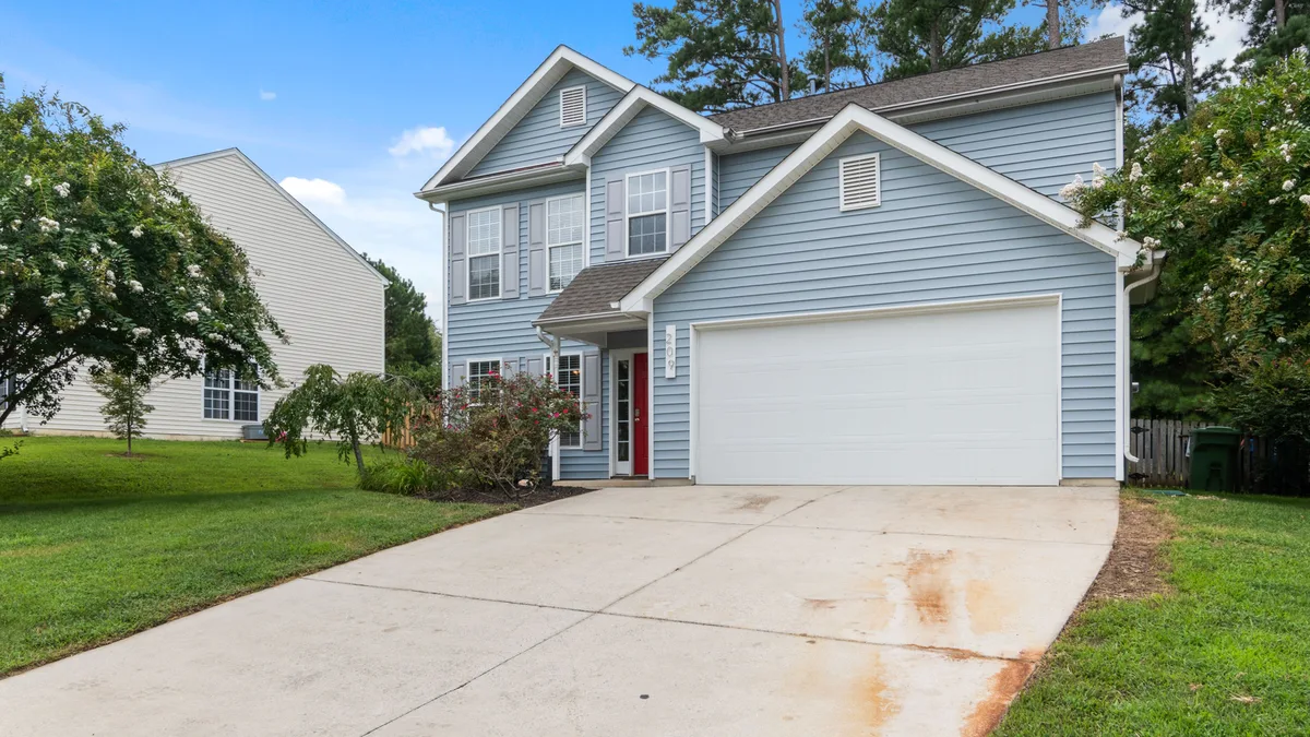 Two-storey suburban house with a spacious driveway