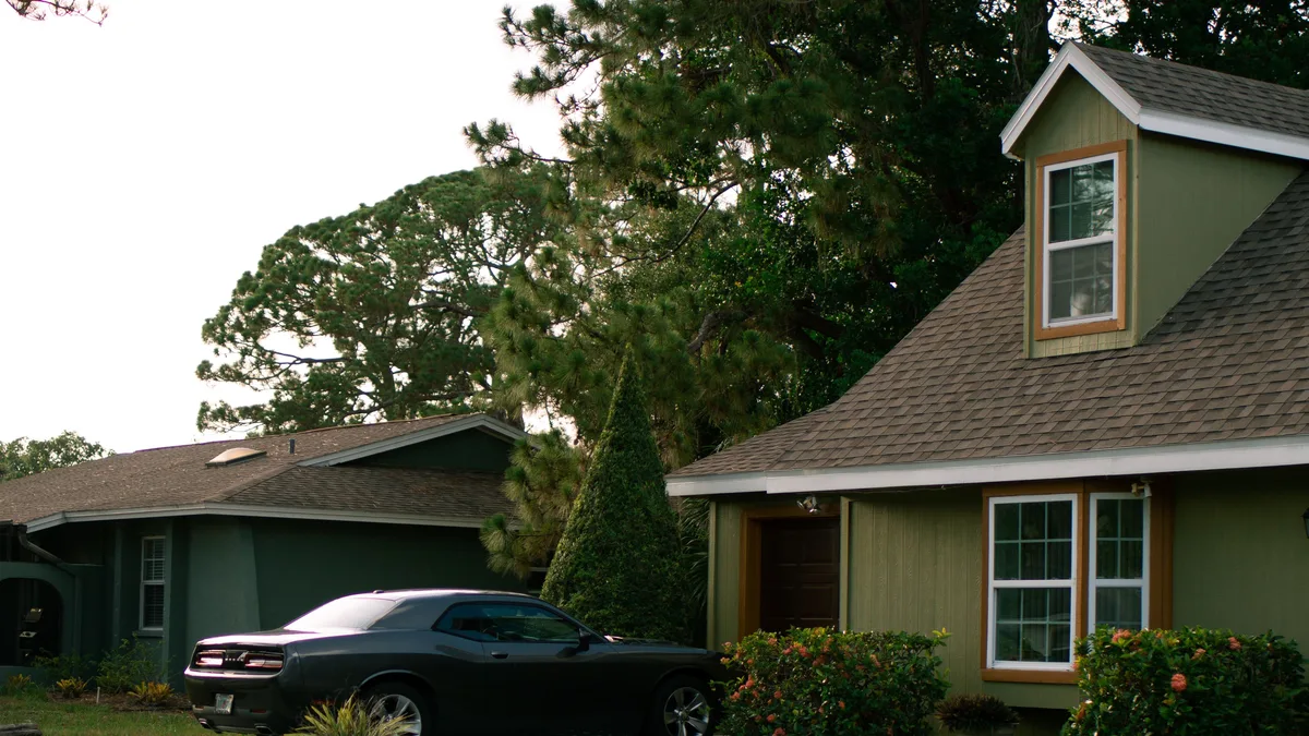 Suburban house with a car parked on the driveway