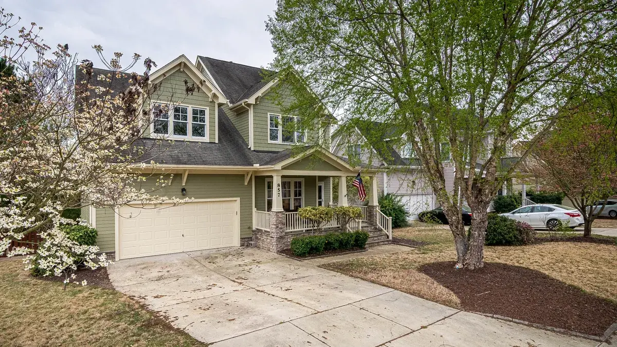 Suburban home with a lush front yard and a concrete driveway