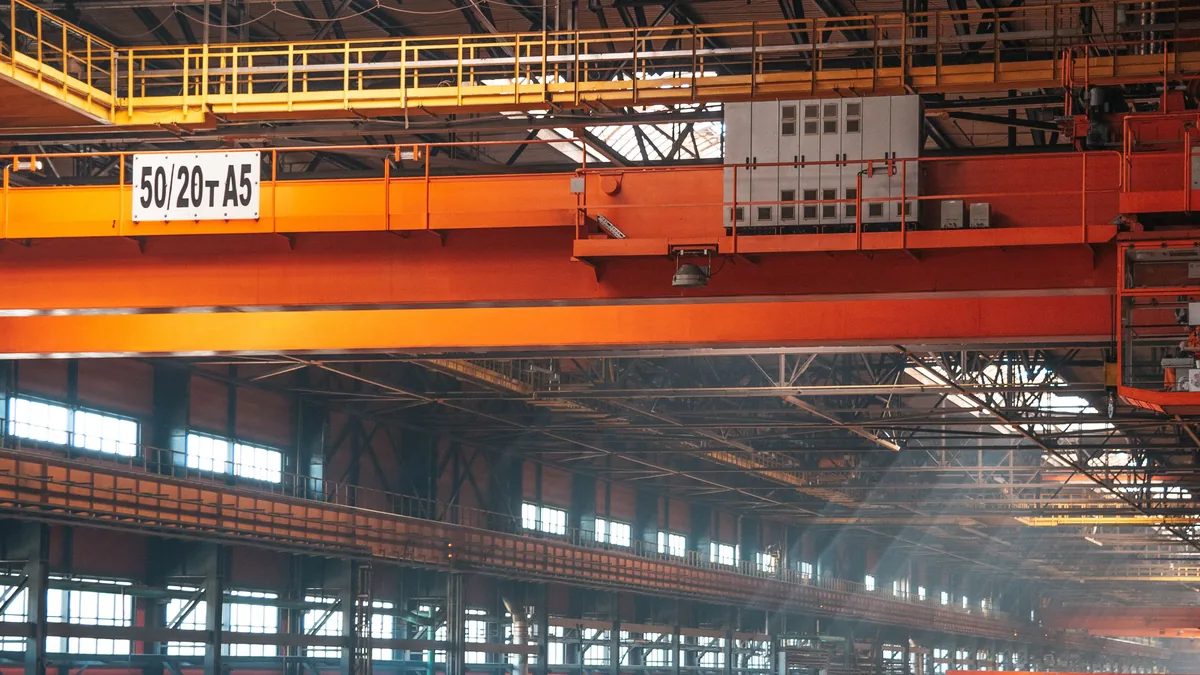 Industrial factory hall with overhead cranes and a heavy-duty concrete floor