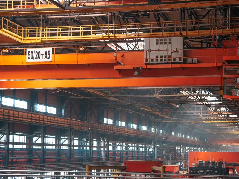Industrial factory hall with overhead cranes and a heavy-duty concrete floor