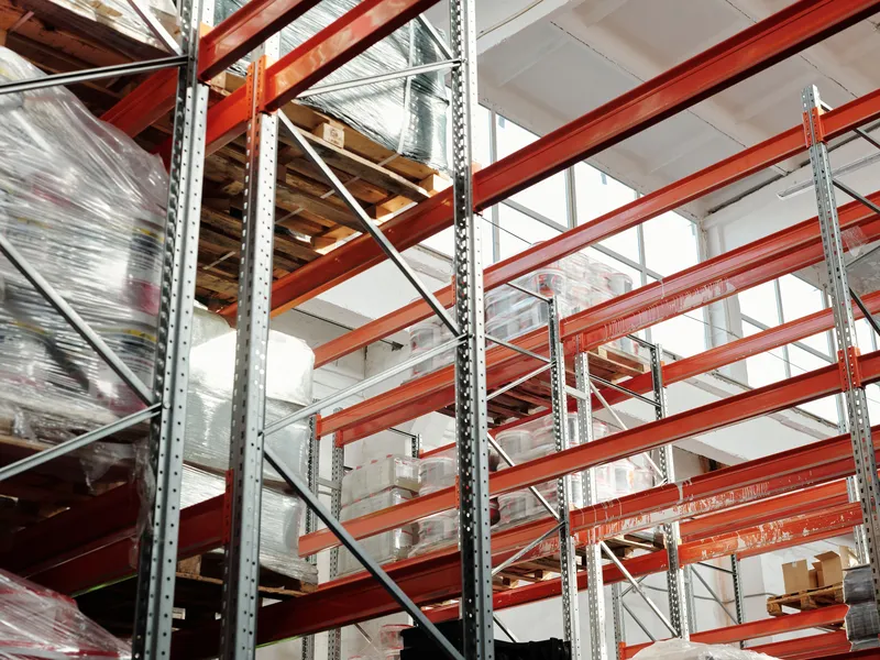 Warehouse interior with pallet racking and a wide concrete floor